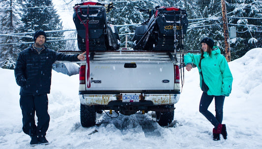 Snowboarders Devun Walsh and Kimmy Fasani with snowmobiles loaded in truck
