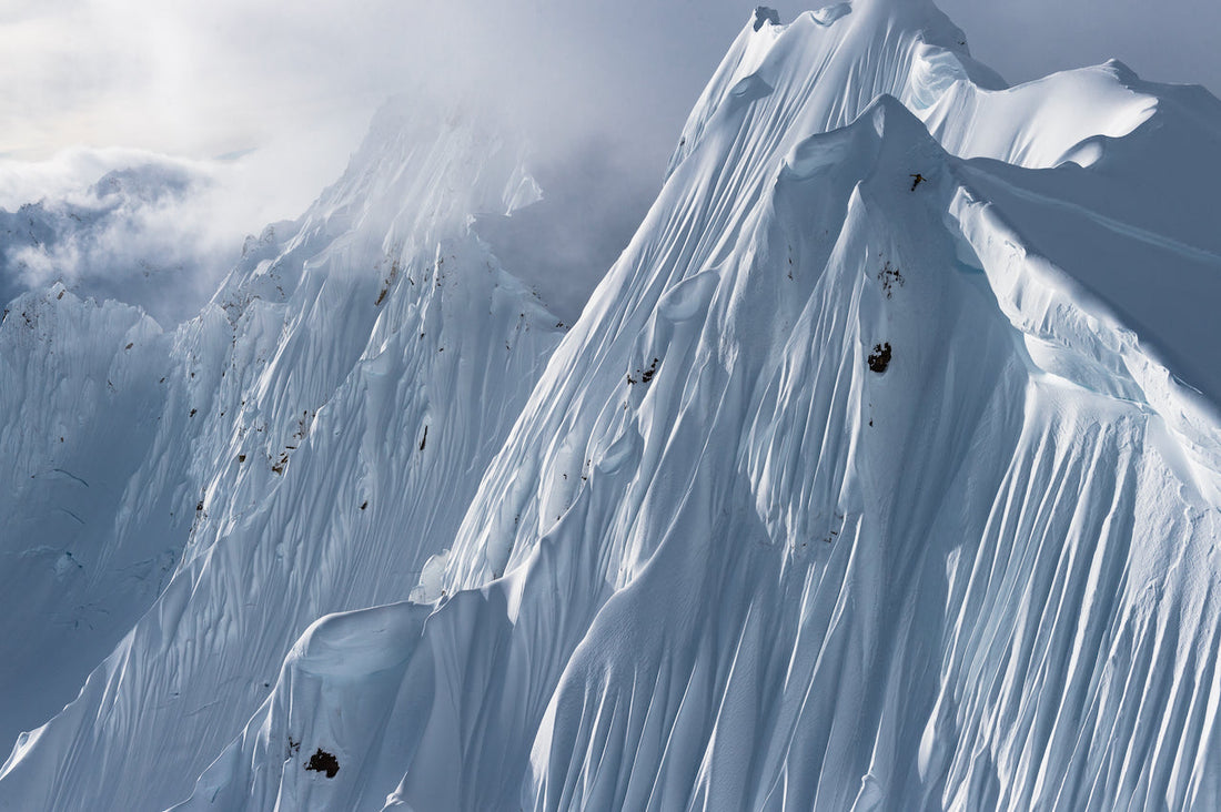 Snowboarder Jason "JRob" Robinson drops into a fluted spine wall