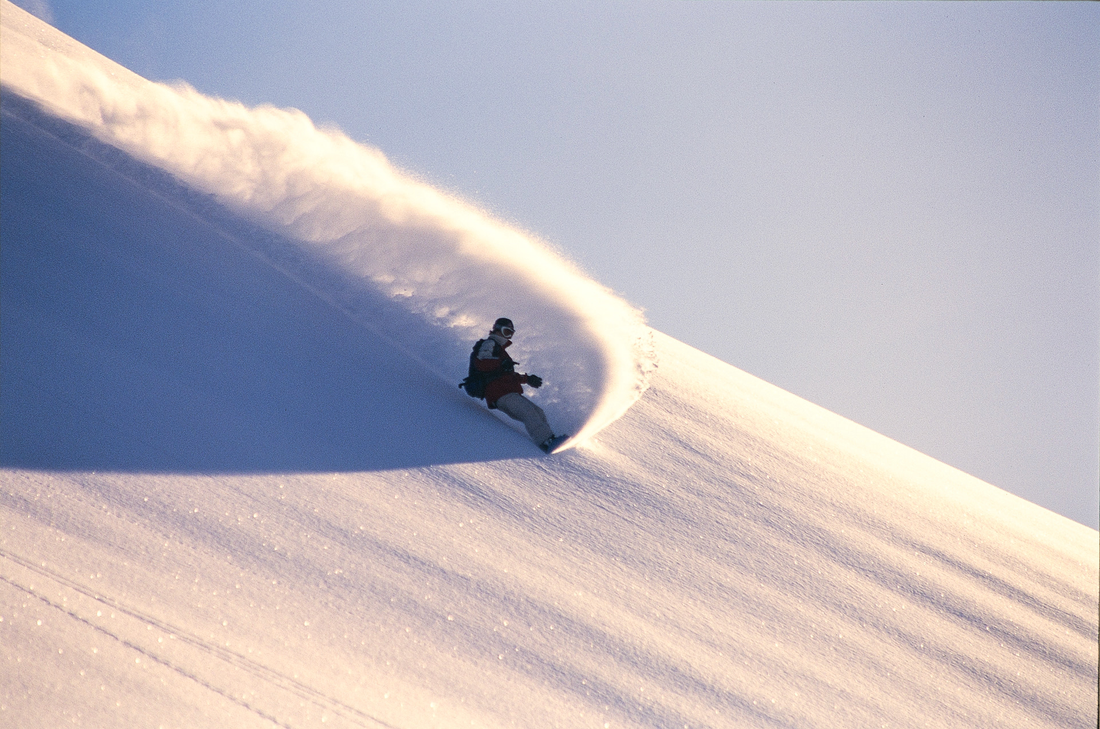 Snowboarder Tina Basich Carves a Beautiful Backlit Powder Turn 
