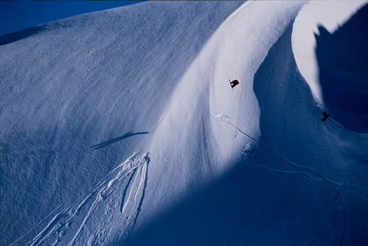 Professional snowboarder Travis Rice goes over a jump on Haines Pass